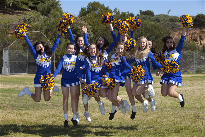 School cheer leading squad leaping into the air